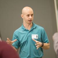 high school students interacting with a computing presenter